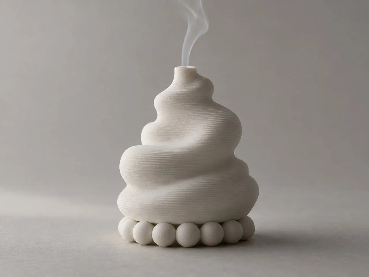 Kabut with a thin line of incense smoke rising from the top.