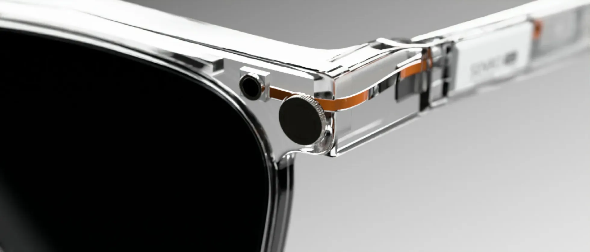 The corner of the frame with the pairing button and camera.